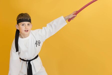 Boy age 7 fighting like karate playerの写真素材