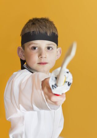Boy age 7 fighting like karate playerの写真素材