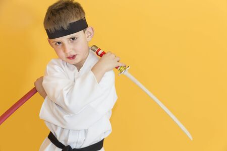 Boy age 7 fighting like karate playerの写真素材