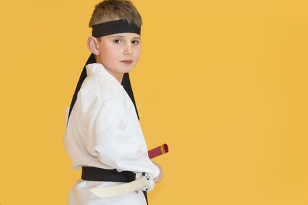 Boy age 7 fighting like karate playerの写真素材