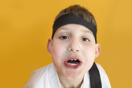 Boy age 7 fighting like karate playerの写真素材