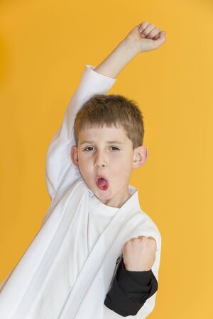 Boy age 7 fighting like karate playerの写真素材
