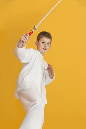 Boy age 7 fighting like karate playerの写真素材