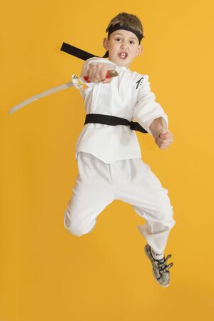 Boy age 7 fighting like karate playerの写真素材
