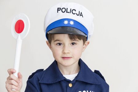 Boy age 6 boy pretending to be a police officerの写真素材