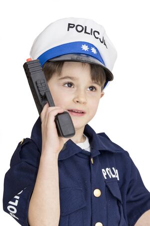 Boy age 6 boy pretending to be a police officerの写真素材