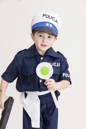 Boy age 6 boy pretending to be a police officerの写真素材