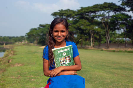 Gowainghat, Bangladesh - November 06, 2019: Girls' education is not so common in third-world countries. But the scenario is changing gradually. This girl is happy when she got admitted to the school.のeditorial素材