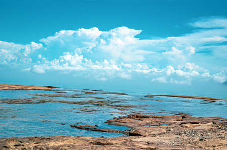 Top view of the mountain, water flowing as waterfalls and beautiful blue sky with clouds. Edge of the mountain and white clouds and blue skyの写真素材