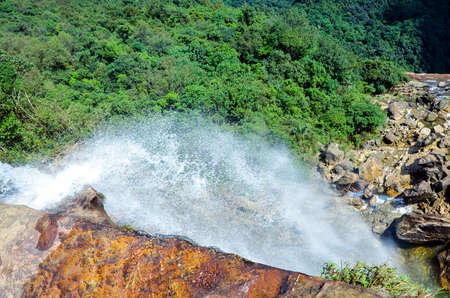 Water splashing from top of the mountain. Waterfall in a forest. High angle of waterfall and water splashingの写真素材