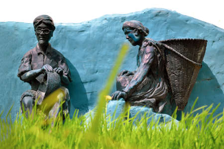 Shillong, India - February 23, 2010: Antique sculpture of traditional household work and shifting (slash and burn farming) cultivation. Selective focus on traditional sculpture and burry foregroundのeditorial素材