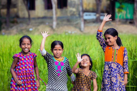 Gowainghat, Bangladesh â November 06, 2019: Village girls enjoying, raising hands, jumping and laughing. Kids passing their leisure time and smiling on the faceのeditorial素材