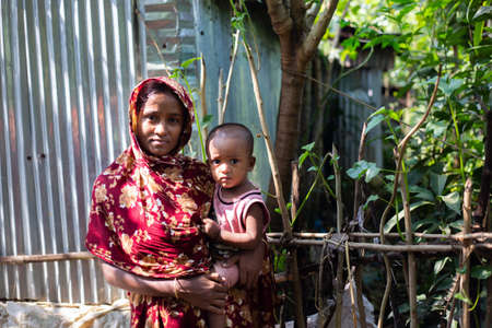 Gowainghat, Bangladesh â November 06, 2019: Women become early mother and malnutrition child on her lap from a rural village.のeditorial素材