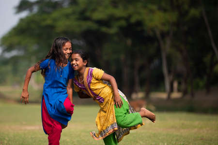 Gowainghat, Bangladesh â November 06, 2019: Girls enjoying funny game called cockfight in the school playground. The winner of the cockfight game, the moment of defeating another girl in the game.のeditorial素材