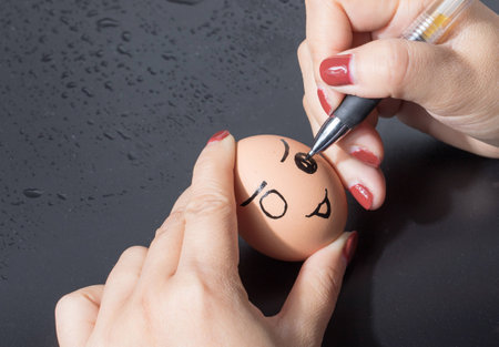 Girl painting on the eggの写真素材