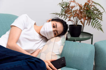 Asian woman getting sick and wearing face mask protectionの写真素材