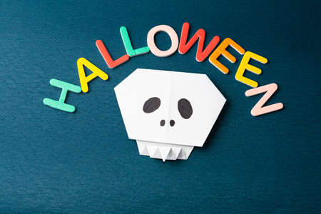 Happy Halloween lettering with pumpkins, skulls, spiders and other decorations