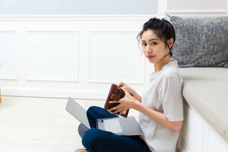 Asian young woman holding credit card and using laptop. Online shopping concept