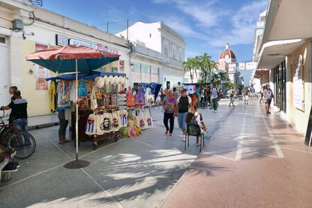 The buzzling street with moving street carts along Cienfuegosの写真素材
