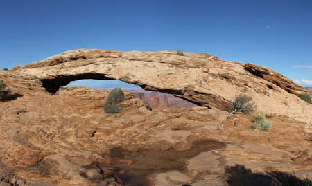 Mesa Arch in Canyonlands Utah America. Also known as Rotary Arch or Trail Arch. Natural stone Arch in front of Blue Sky. Natural formed Red Stone. High resolution in poster format.の写真素材