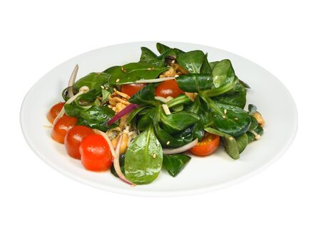 Healthy fresh salad with mussels, spinach and cherry tomatoes on white round plate isolated on white background. Diet conception. Close-up photoの写真素材