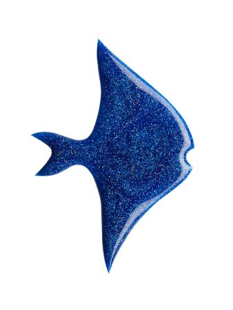 Blot of blue nail polish shaped fish isolated on white background. Macro photo. Top viewの写真素材