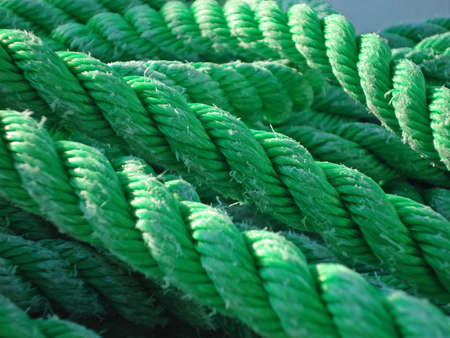 Closeup of green worn twisted style ropeの写真素材