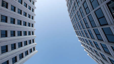 Modern buildings from low angle view against blue sky. Commercial office buildings exteriorの写真素材