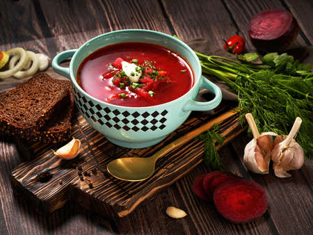 Ukrainian and Russian national red borsch with sour cream and herbs. Bowl of red beetroot soup on dark rustic backgroundの写真素材