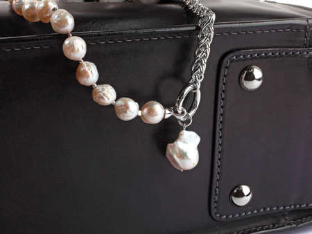 Luxury elegant baroque pearl necklace with pendant on black leather case. Close-up shotの写真素材