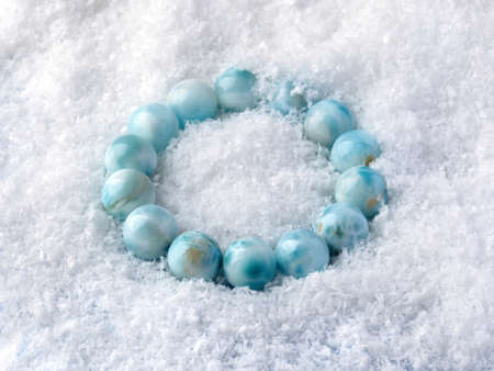 Luxury elegant blue larimar stone bracelet on white snow background. Close-up shotの写真素材