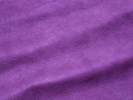 Genuine purple cattle leather texture background. Macro photo