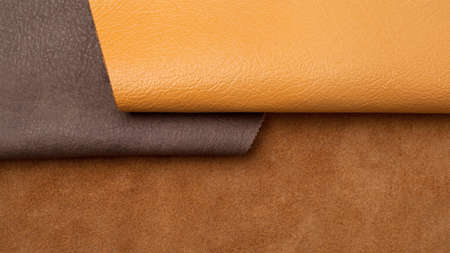 Different colors natural leather textures samples on brown backgroundの写真素材