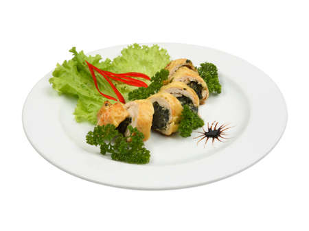 Close up of filled chicken fillet with spinach on white round plate isolated on white backgroundの写真素材
