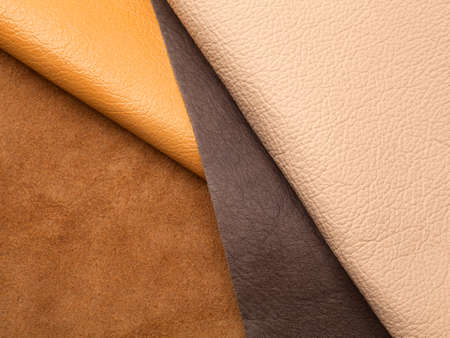 Different colors natural leather textures samples on brown backgroundの写真素材