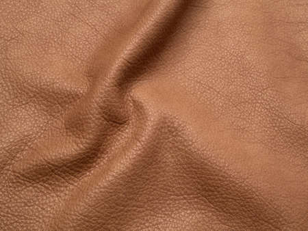 Genuine brown cattle leather texture background. Macro photo