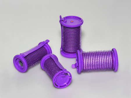 Several purple hair curlers on gray backroundの写真素材