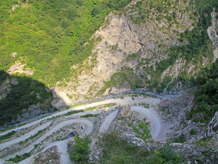 Aerial view road curve construction amidst mountains, North Ossetia-Alania, Russiaの写真素材