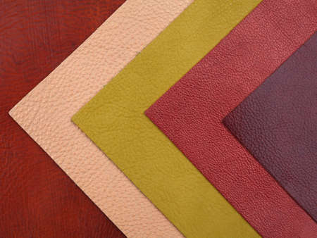 Different colors natural leather textures samples on red leather background