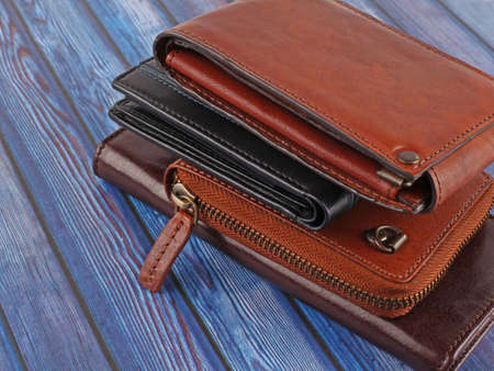 New leather multicolored wallets on blue wooden backgroundの写真素材