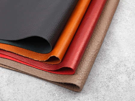 Different colors natural leather textures samples on gray stone backgroundの写真素材