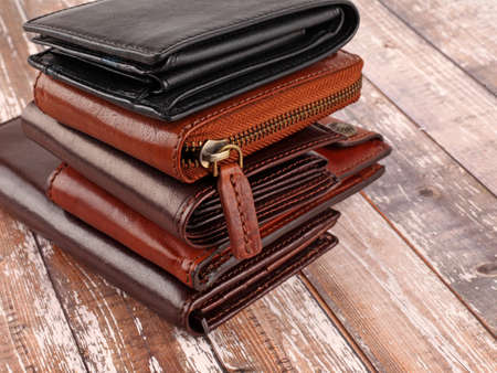 New leather multicolored wallets on wooden background. With copy spaceの写真素材