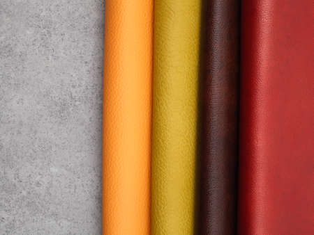 Different colors natural leather textures samples on gray stone backgroundの写真素材
