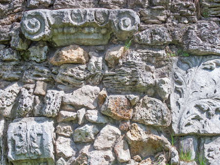 Natural old stone wall with plants backgroundの写真素材