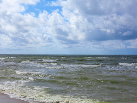 Calm landscape beach. Green sea waves with foamの写真素材