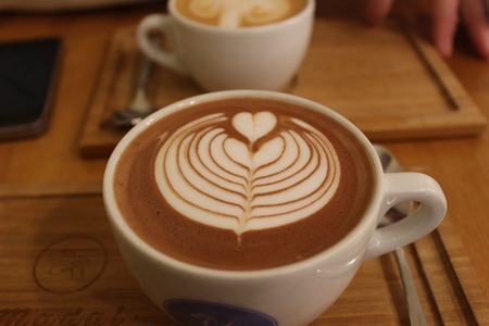 latte art heart at a hot chocolate in a cupの写真素材