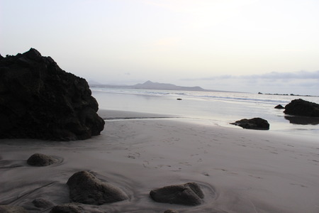 calm sunset at the beach with stonesの写真素材