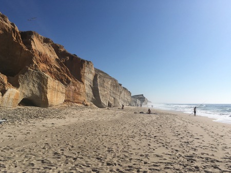 beautiful beach with cliffs in the backgroundの写真素材