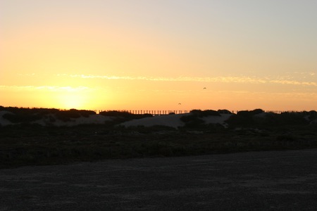 Dramatic sunset at the beach with cloudy skyの写真素材