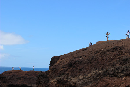 Tourists standing on a cliff and taking picturesの写真素材